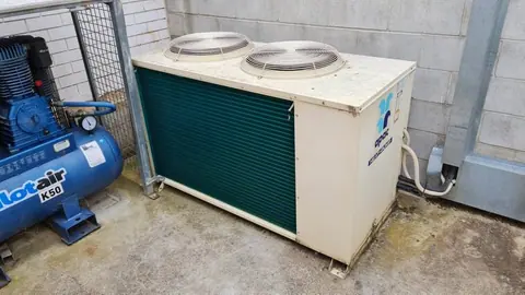 Ceiling cassette air conditioning unit installed flush into a suspended ceiling